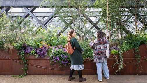 Visitors exploring the urban garden at Castlefield Viaduct, Manchester